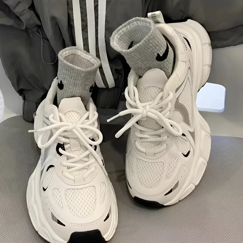 Beige mesh platform sports shoes with a wedge heel and front lace-up fastening on a rubber sole.
