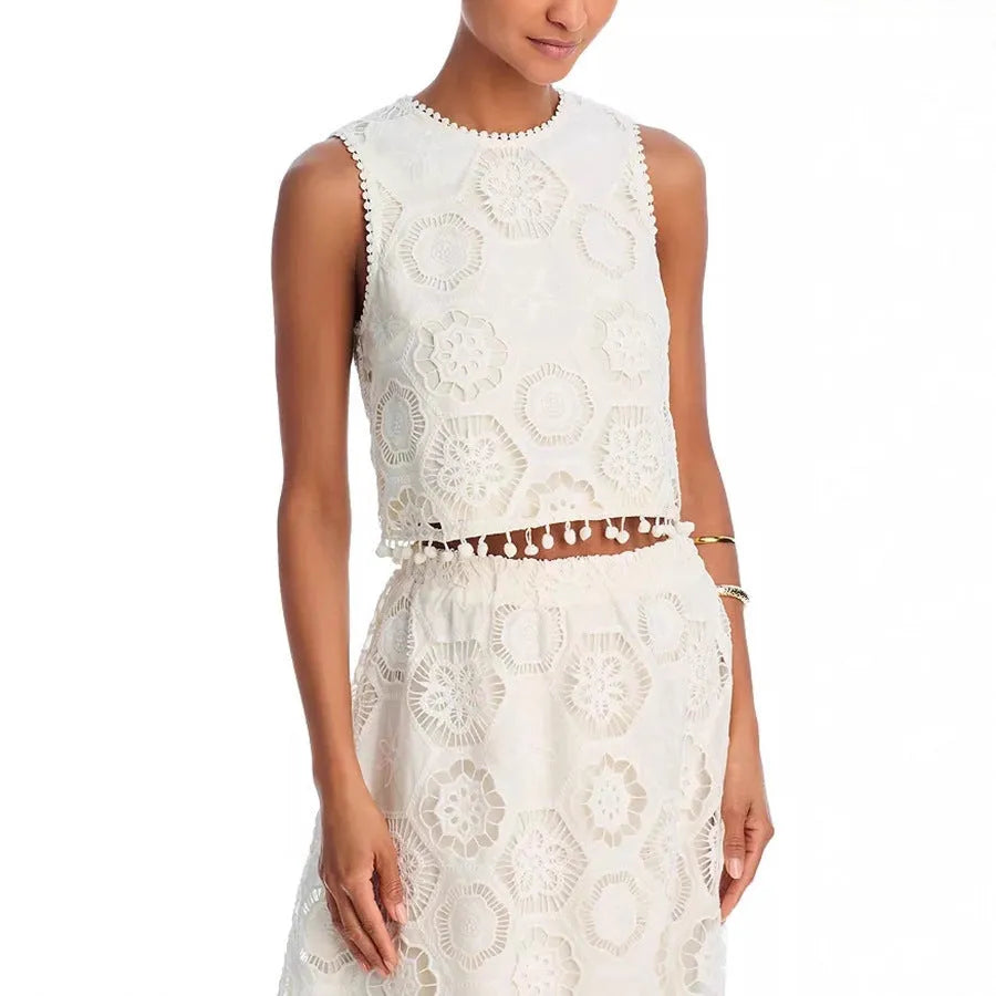 White women's sleeveless top and long skirt suit set with retro embroidery details.