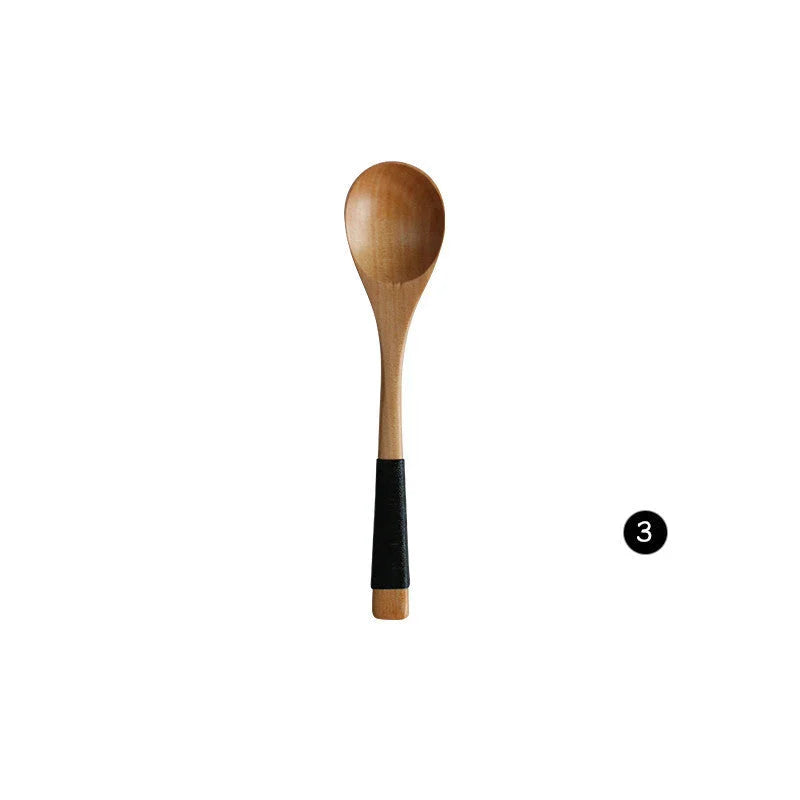 Japanese-style wooden bamboo spoon and fork set on a wooden table