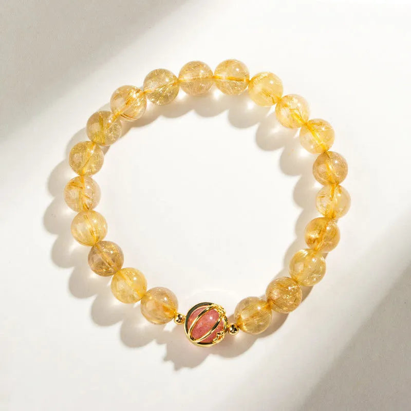 Gold rutilated quartz crystal bracelet with diamond-shaped links and natural citrine beads