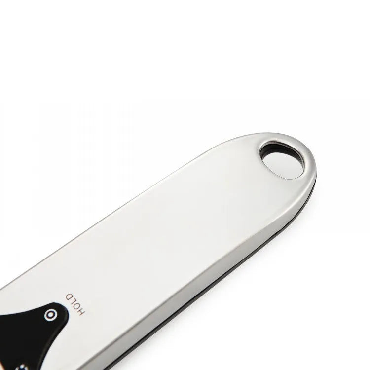Smart digital kitchen measuring spoon with backlit LCD display showing weight and volume measurements.