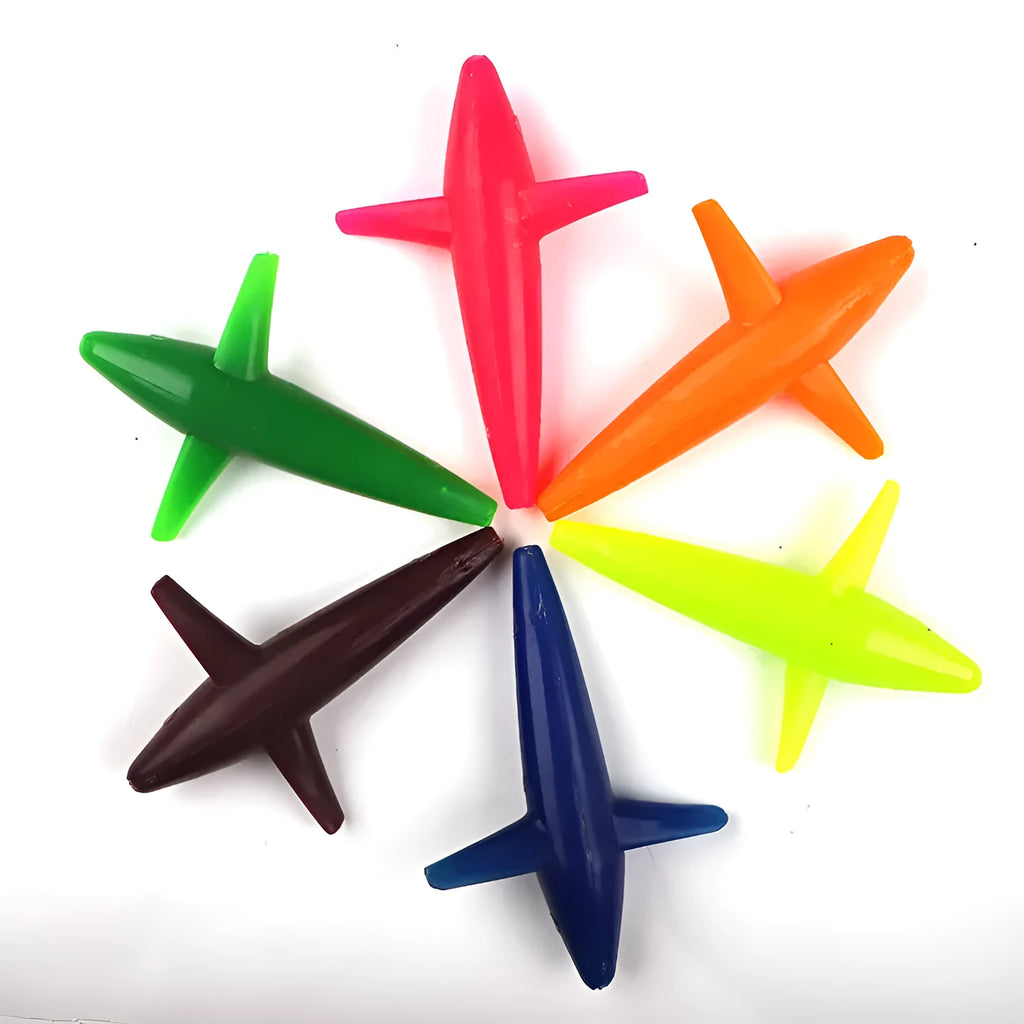 Multi-colour aircraft sea fishing lure in blue, green, and purple on a sandy beach
