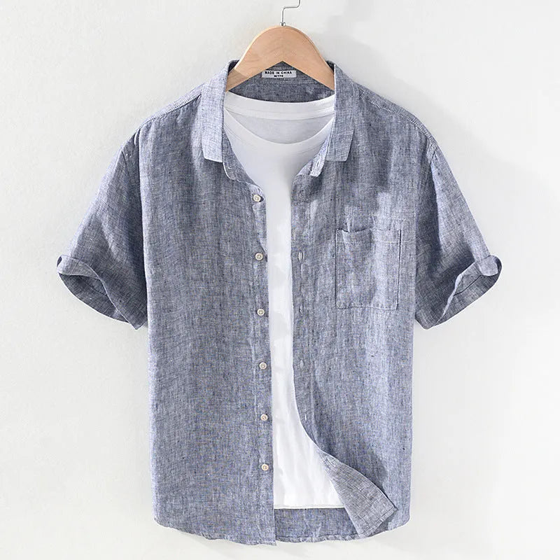 Men's short sleeve linen shirt with square collar in raw jute colour, laid flat.