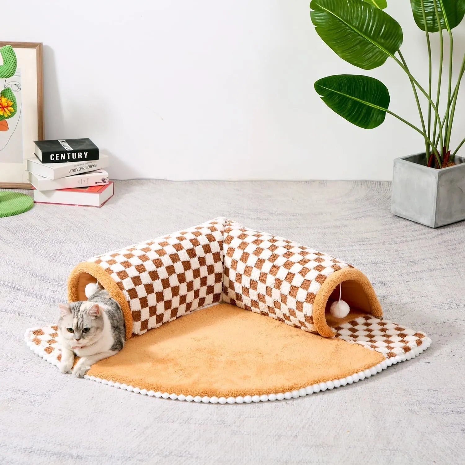 Large plush fan-shaped dog and cat bed with central tunnel, in coffee colour, on a floor.