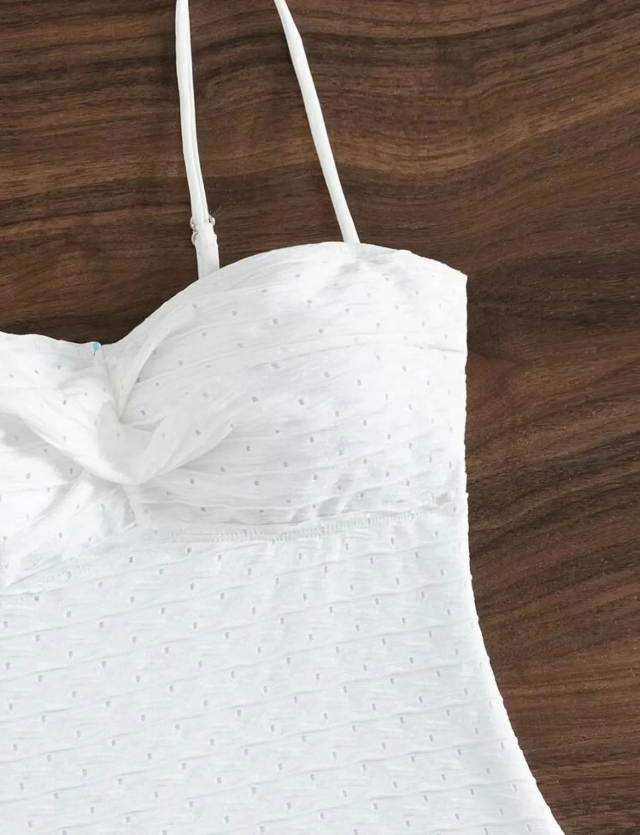 White women's one-piece swimsuit with sling design on mannequin