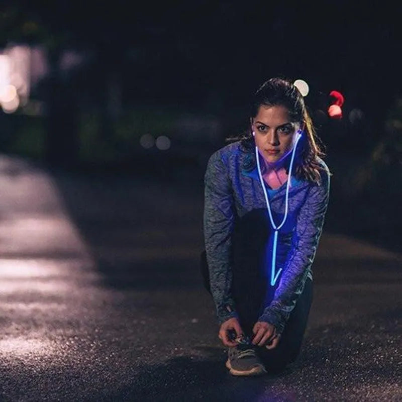 Blue Magic Light LED earphones with illuminated shells and a 3.5mm plug, showing the inline remote control.