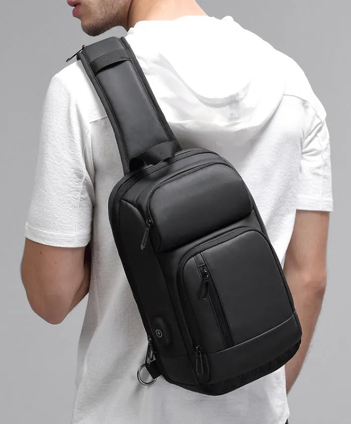 Black PVC outdoor shoulder bag with air cushion strap and internal organisation pockets