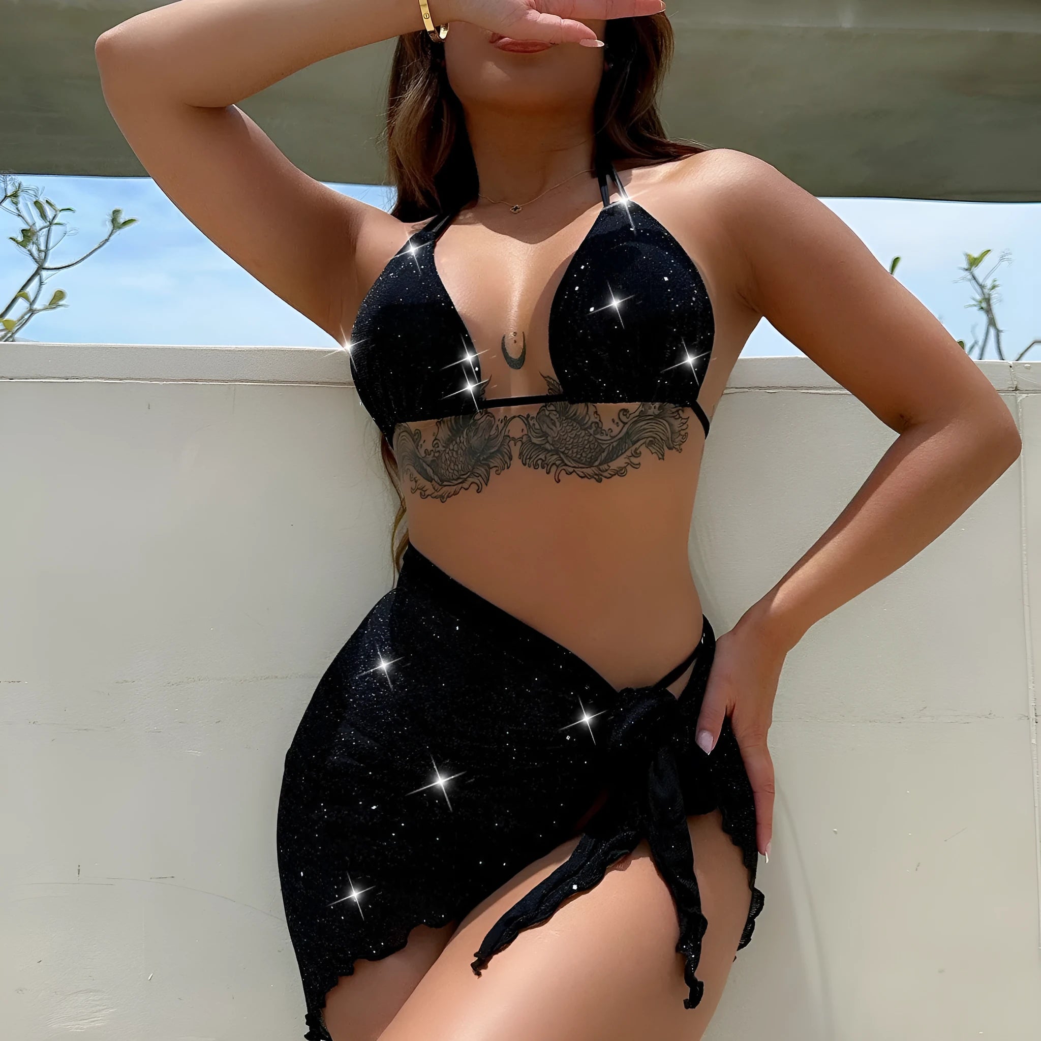 Black three-piece bikini swimsuit set with top and shorts on a mannequin.