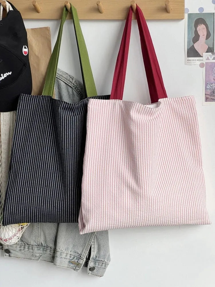 Canvas multi-layer tote shoulder bag showing three colour options: light pink stripes, black and gray plaid, dark gray stripes