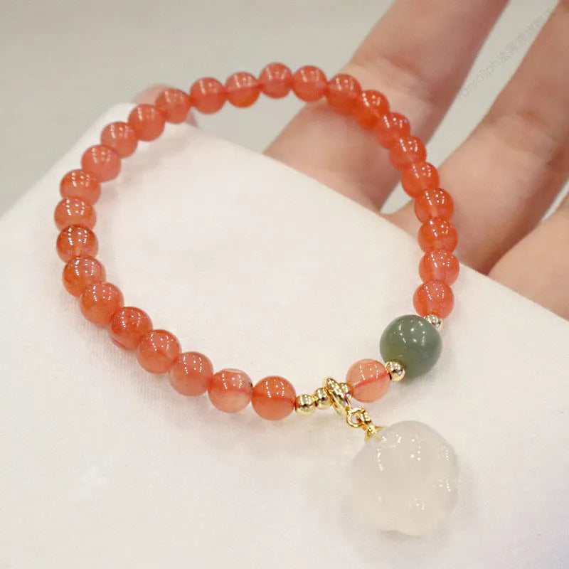 Polished red agate and green jade women's bracelet with a cat's paw charm.