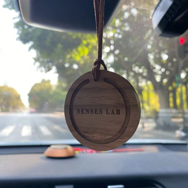 Round black walnut wood car air freshener pendant with jasmine green tea scent, 5cm diameter, brown colour variant