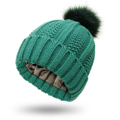 Cozy satin-lined knit beanies with pom poms in various colors for women's winter fashion