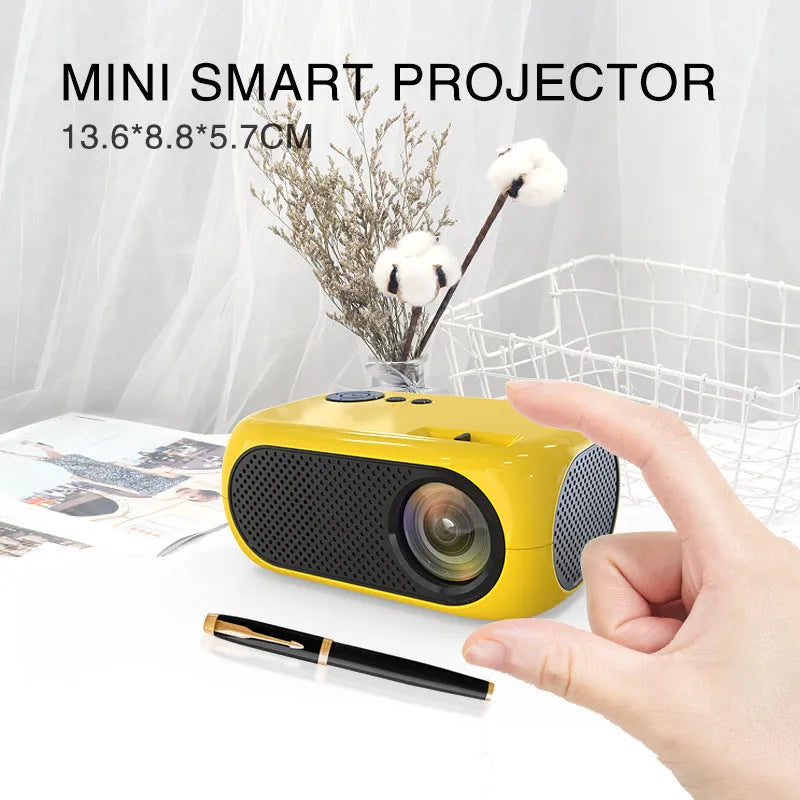 M24 micro mini LED projector in gold or white colour with compact design showing power adapter and AV cable accessories