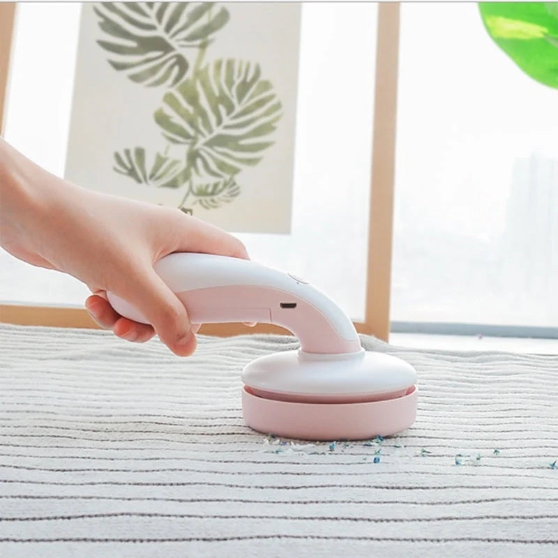 Mini desktop vacuum cleaner in pink, green, blue, and grey for dust removal