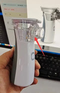 White handheld microporous medical nebuliser with mouthpiece, compact size 50x48x130mm