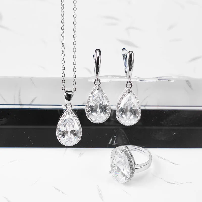 Drop-shaped zircon non-fading three-piece jewellery set gold plated with mixed gem inlaid pendant in emerald gold colour on white background