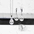 Drop-shaped zircon non-fading three-piece jewellery set gold plated with mixed gem inlaid pendant in emerald gold colour on white background