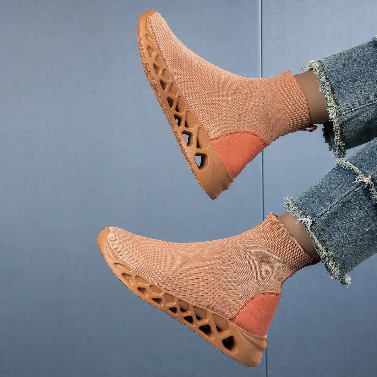 Women's terracotta coloured stretch mesh socks boots with flat heel and round toe on a white background.