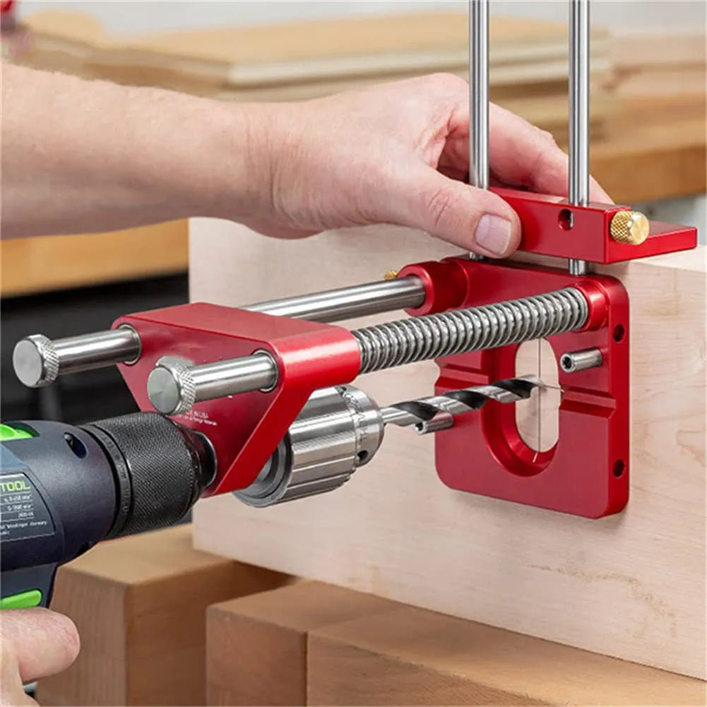 Alloy steel woodworking drill locator with red polymer handle on a wooden surface