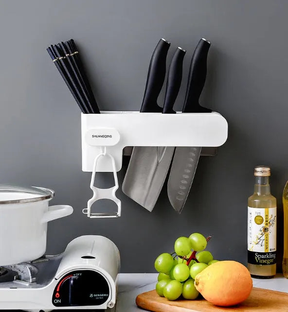 White plastic kitchen knife rack mounted on wall with dimensions 10.6 cm wide by 26 cm tall
