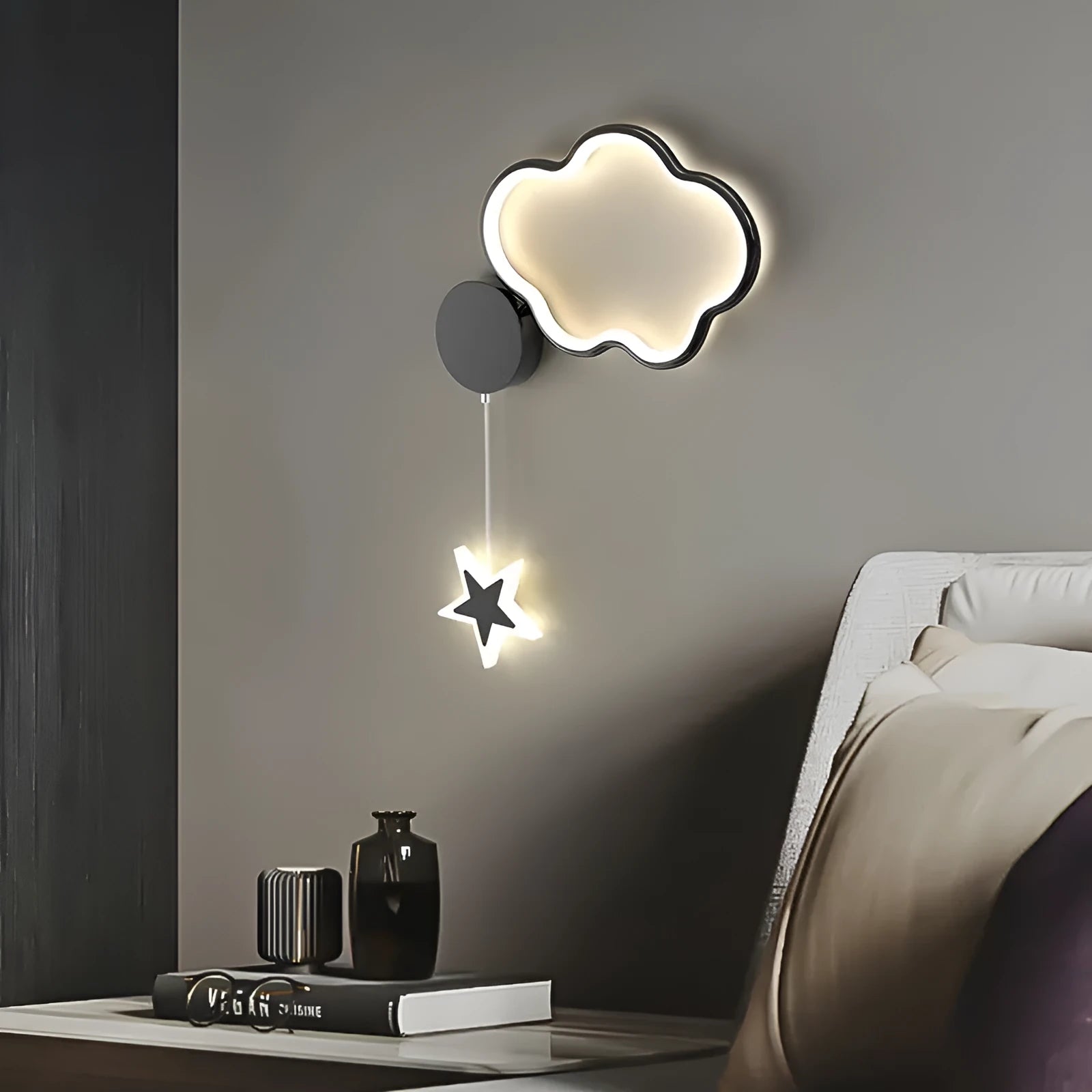 White cloud-shaped children's wall lamp with LED light mounted beside a bed.