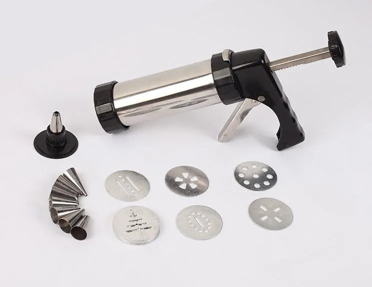 Stainless steel biscuit press gun with assorted cookie moulds and piping nozzles for baking.