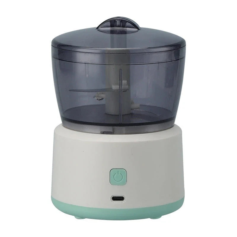 Compact electric meat grinder with stainless steel construction and transparent mincing cup