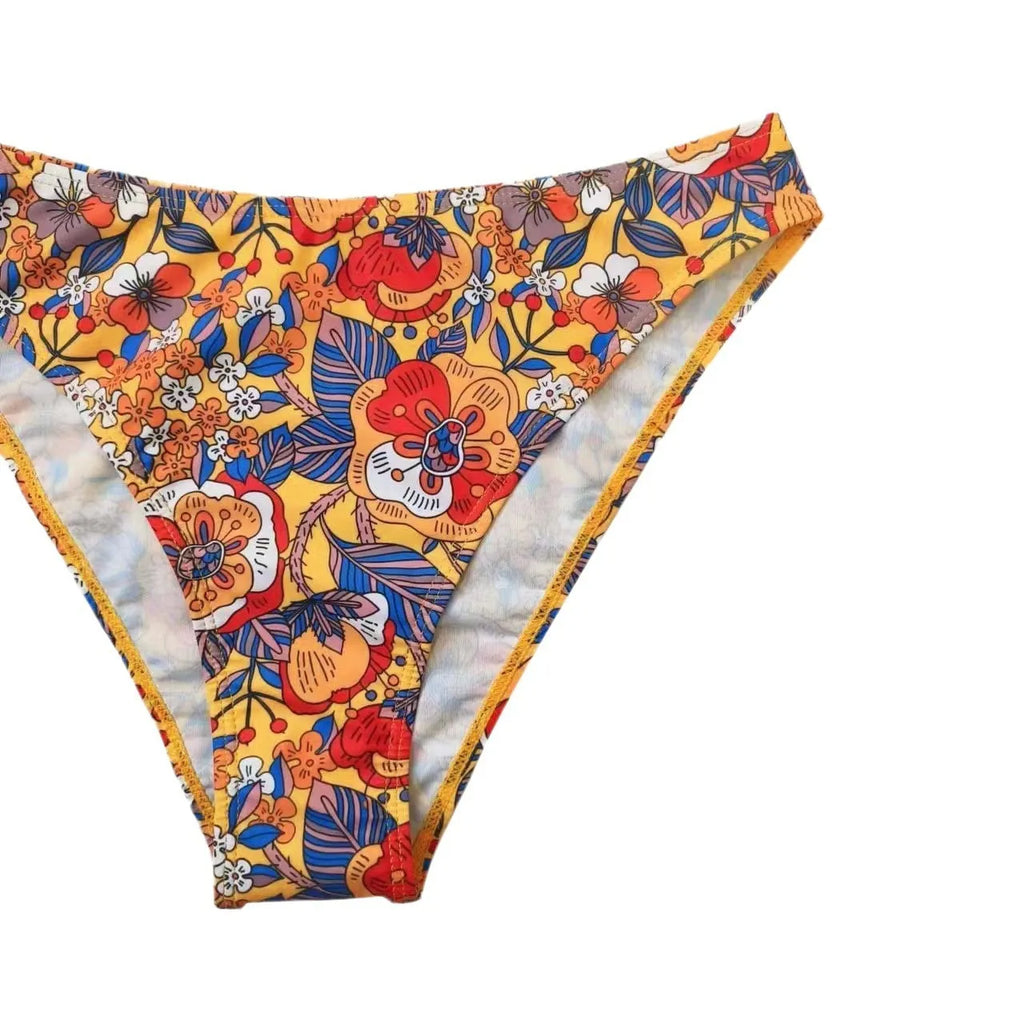 Plus size women's floral print bikini swimsuit with strap design on white background