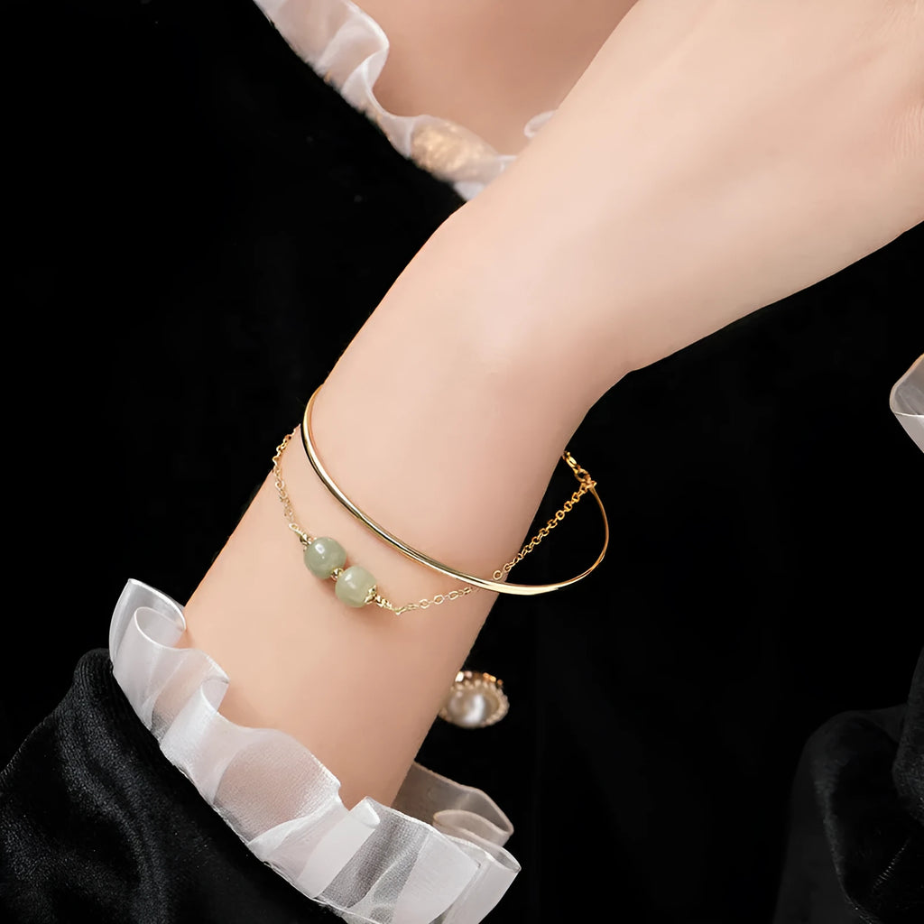 Women's jade bracelet with gold inlay detailing showing single bead version