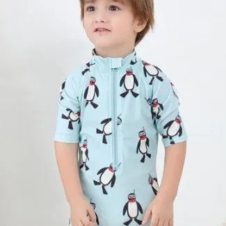Boys' long sleeve penguin print swimsuit set with matching swim cap for sun protection.