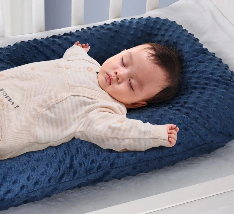 Newborn bionic nap bed in blue and yellow, featuring anti-pressure design and washable fabric