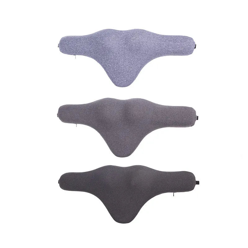 Dark gray memory foam car neck pillow on a car headrest.