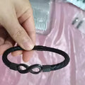 Hand-woven stainless steel leather bracelet in black on a white background, size 23cm