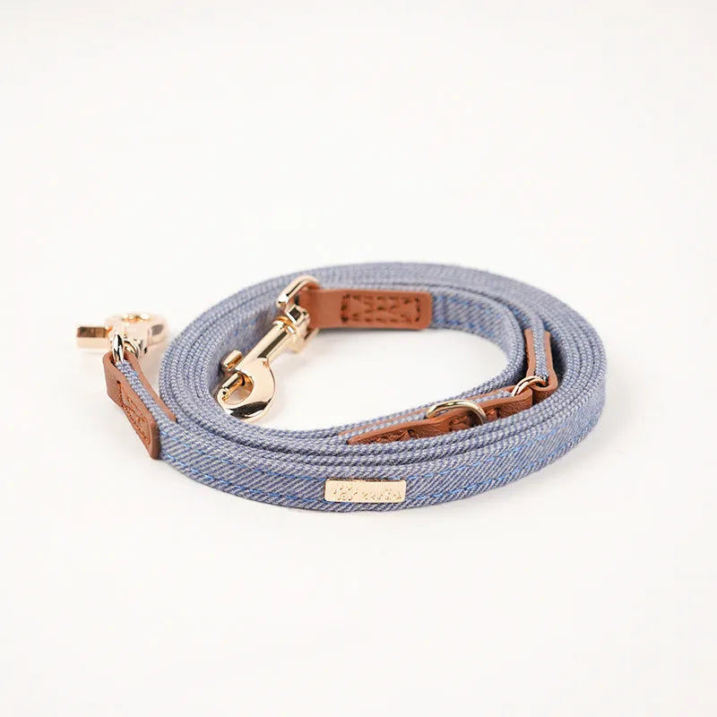 Adjustable mohair dog collar with nameplate and hand holding rope in cement gray