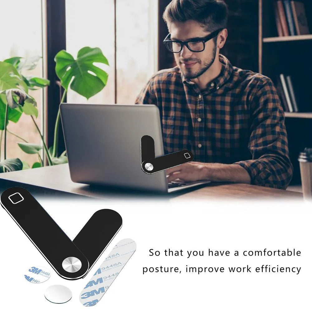 Black aluminium laptop phone holder mounted beside laptop screen showing dual-screen setup