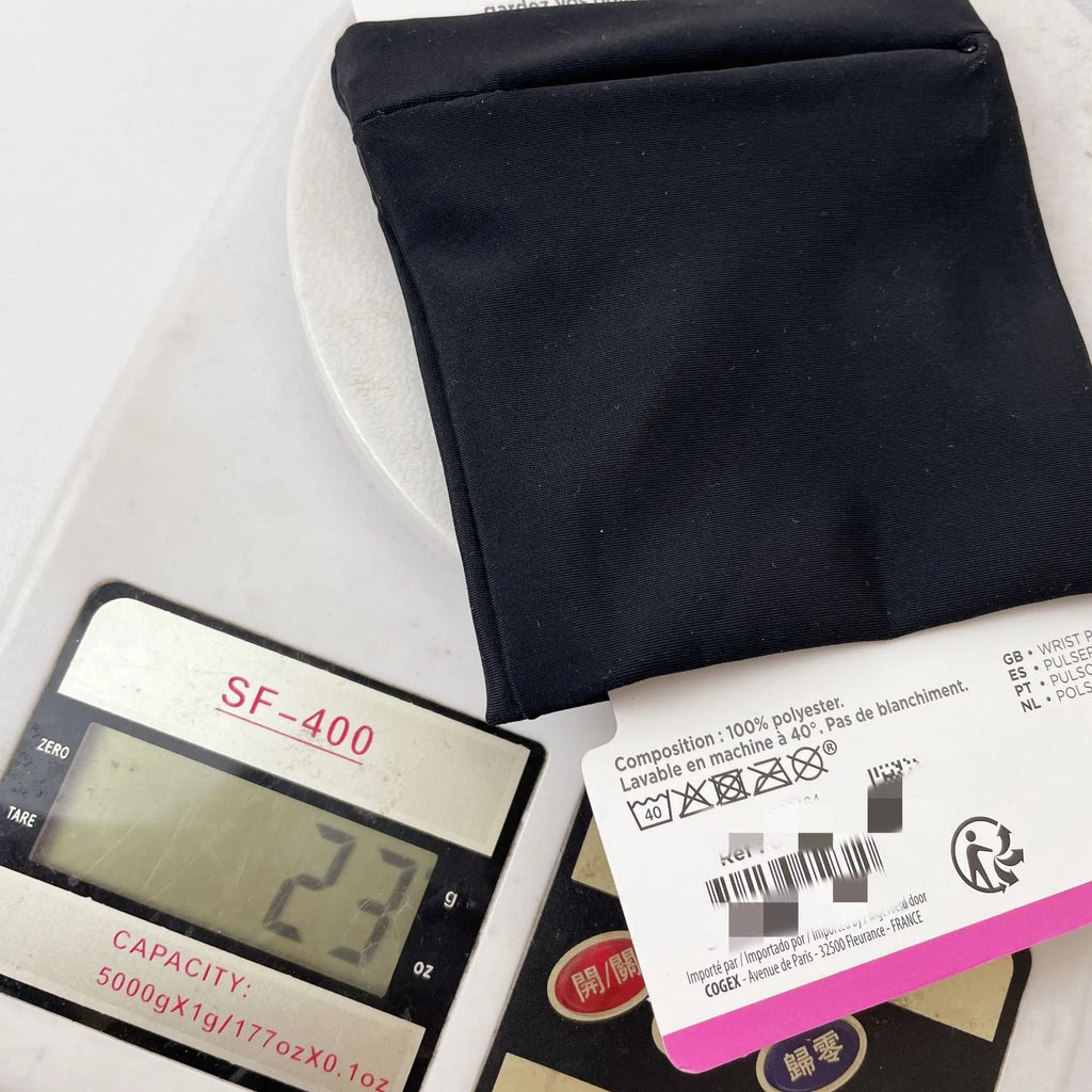 Compact 10 by 10.5 cm black armband sleeve for mobile phone, shown with packaging.
