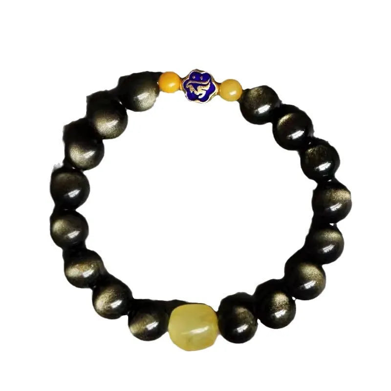 Golden obsidian bracelet with carved zodiac symbols on geometric beads