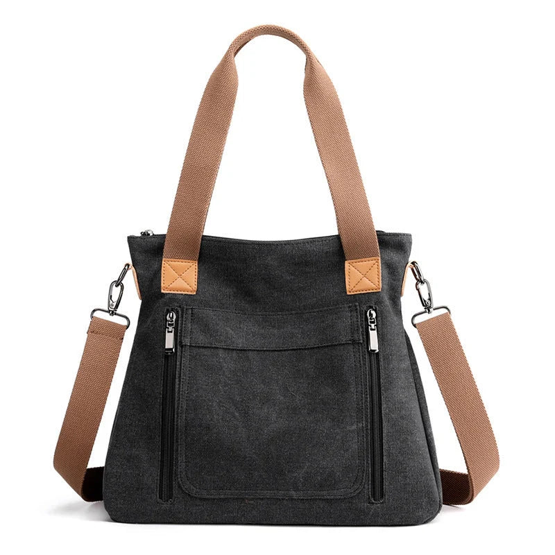 Women's canvas shoulder bag in multiple colours, showcasing spacious interior and zipper closure.