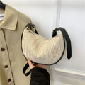 Women's woven straw crossbody bag showing textured surface and internal phone pocket