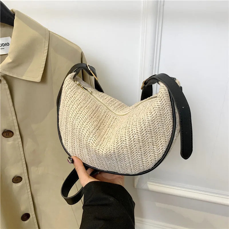 Women's woven straw crossbody bag showing textured surface and internal phone pocket