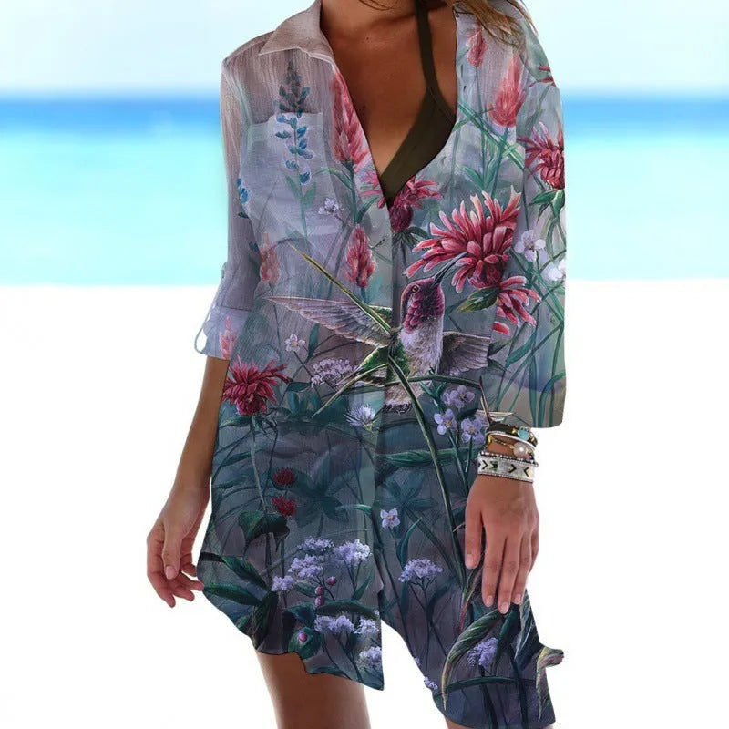 Close-up of a women's slim-fit blouse with a detailed 3D bird and flower digital print on a cardigan-style sleeve.