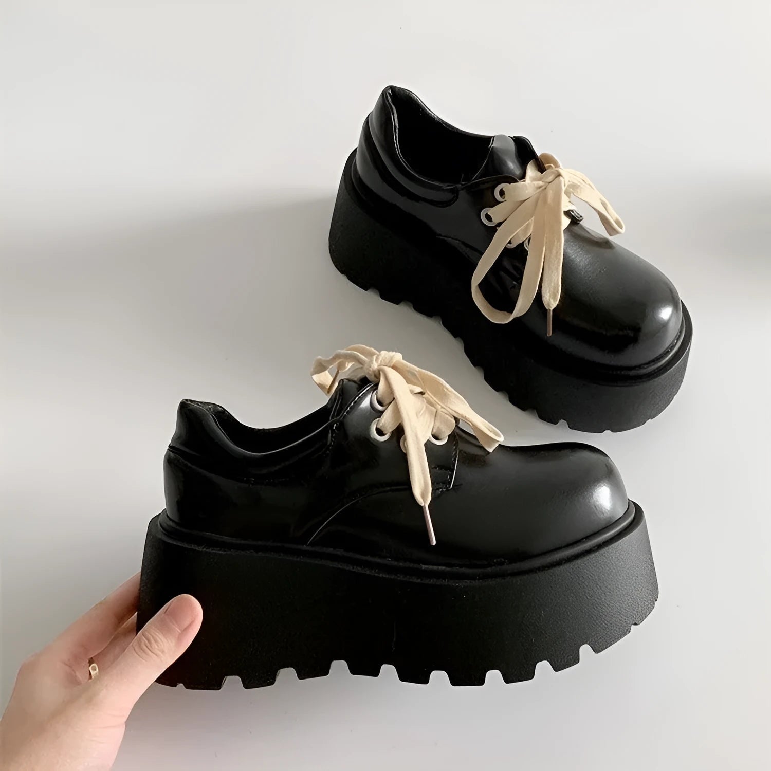 Matte black women's lace-up platform shoes with thick rubber sole and retro block heel.