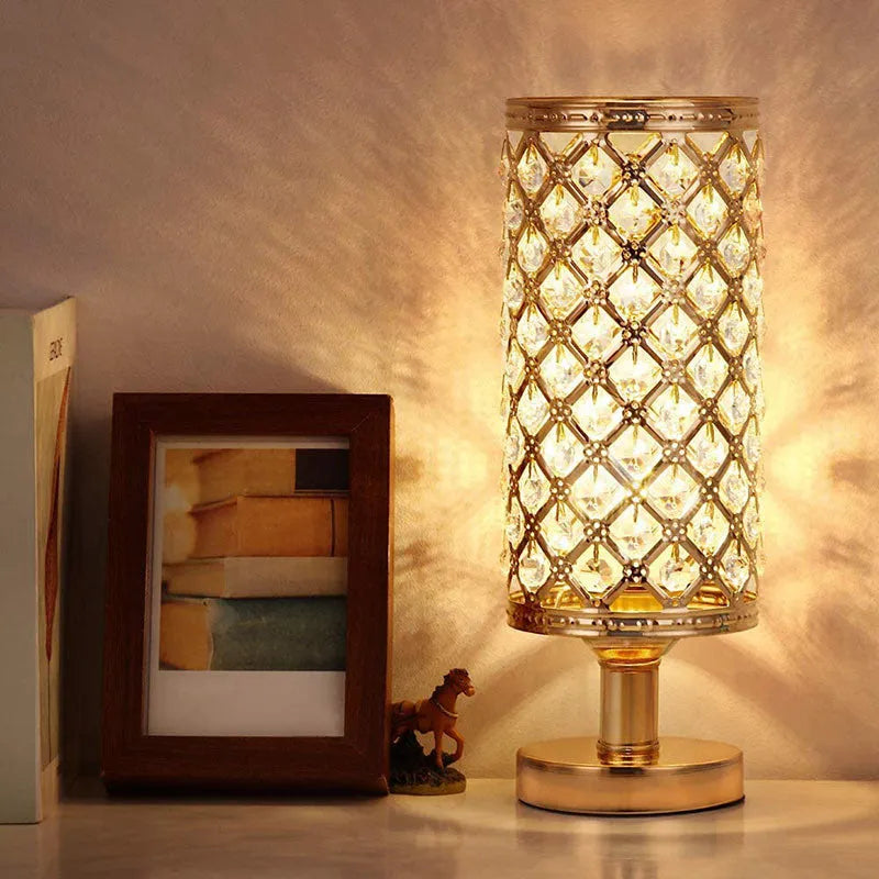 Modern crystal table lamp with metal base and hollow-carved shade in gold finish