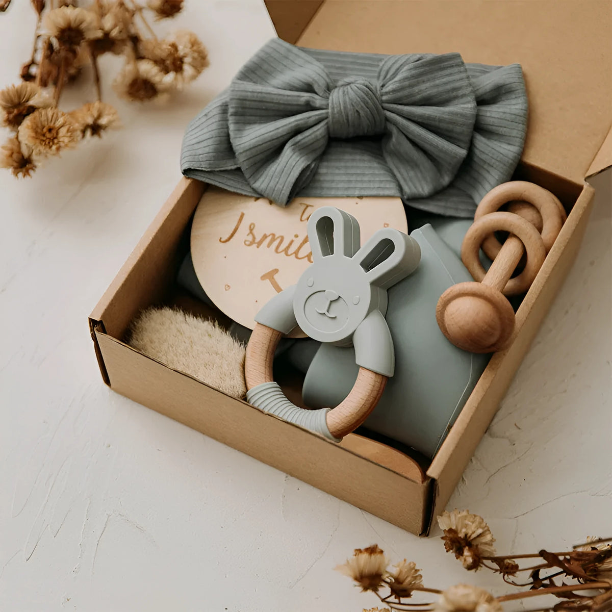 Newborn baby shower toy set with 6 bath toys in peach, blue, and brown from wood and chemical fibre