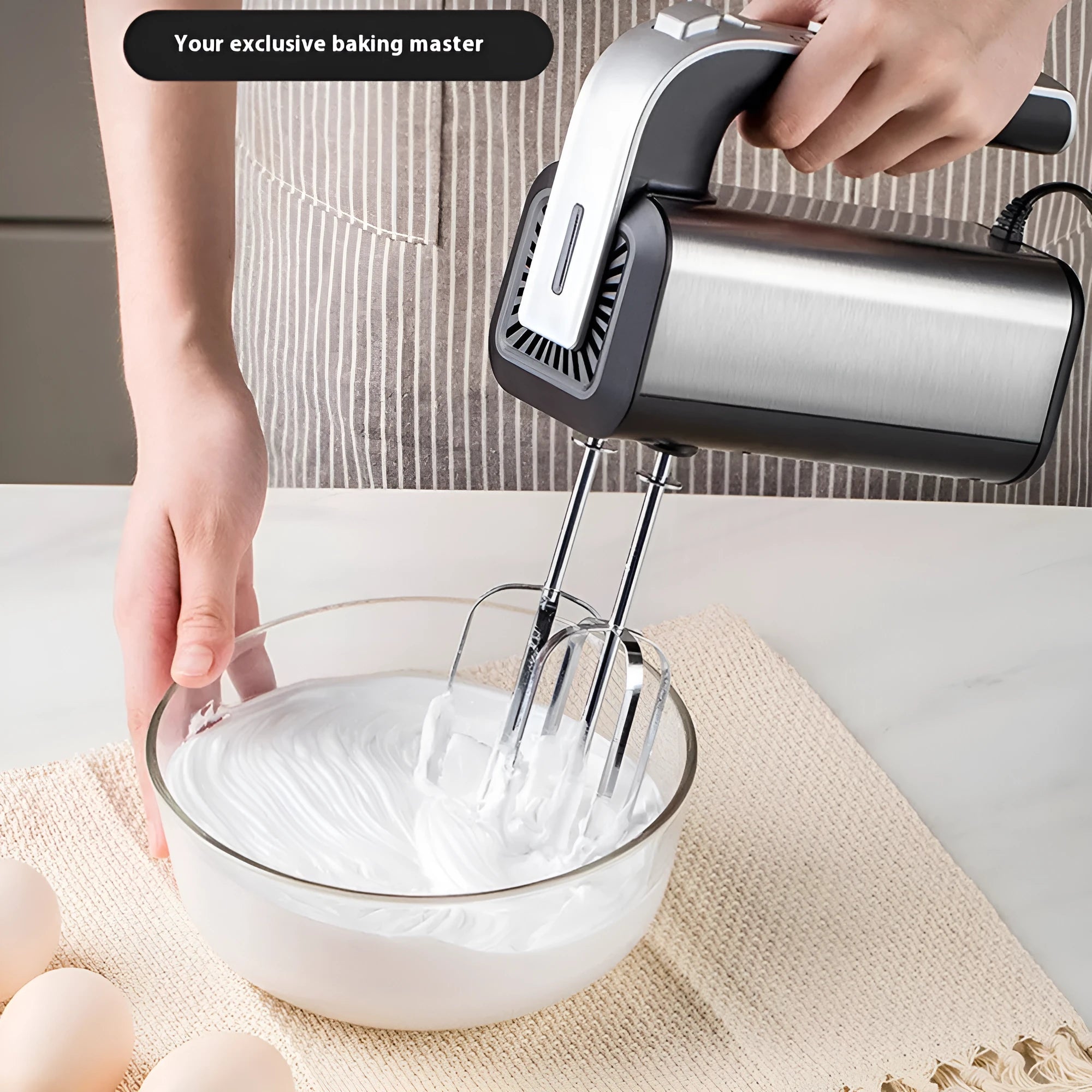 Silver mini electric handheld whisk with stainless steel beaters on a 5-speed control unit.