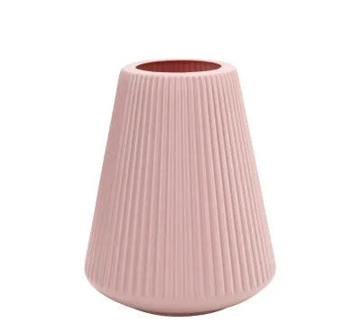 Colourful melamine plastic decorative flower vase on a desk, showing white, pink, green, and blue colour options.