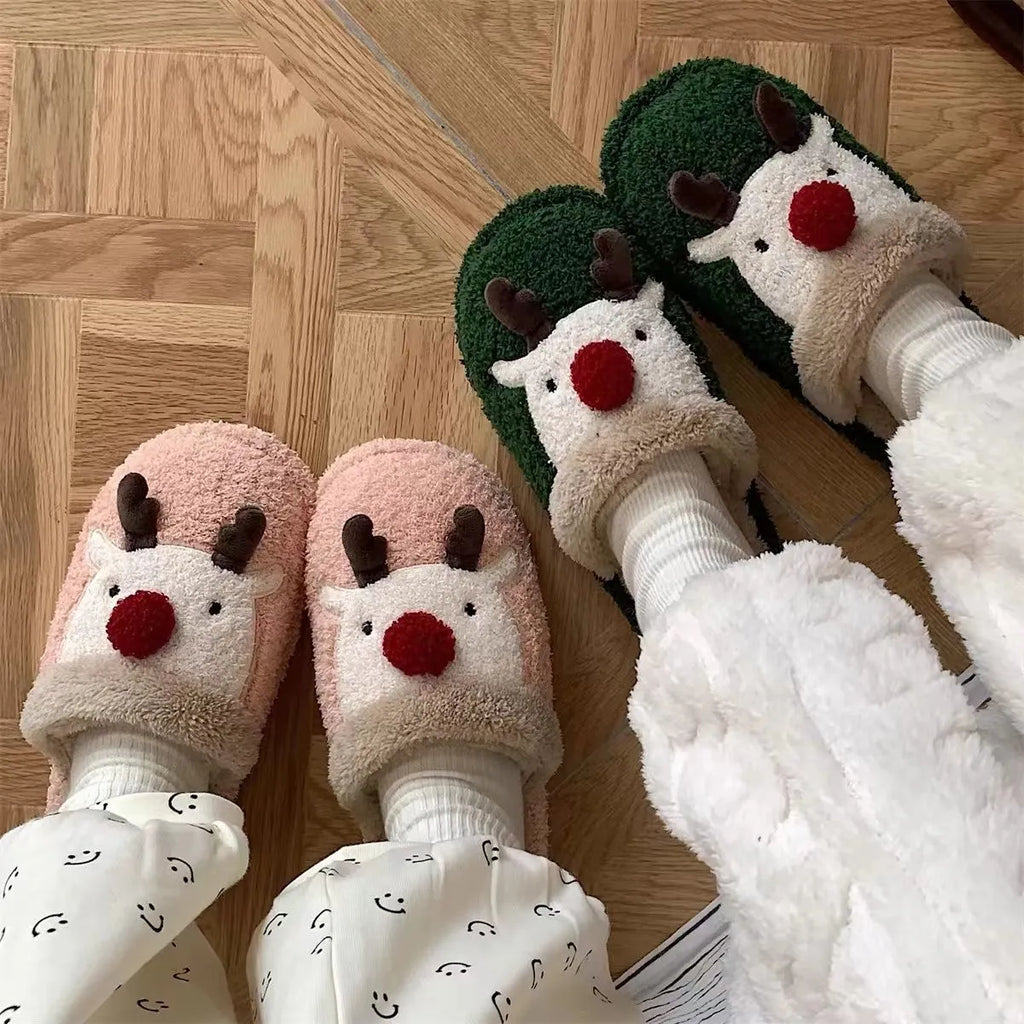 Women's green plush Christmas elk slippers with non-slip PVC sole, shown on a white background.