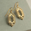 Gold flower window hollow stud earrings with geometric copper design and electroplated brass-style finish