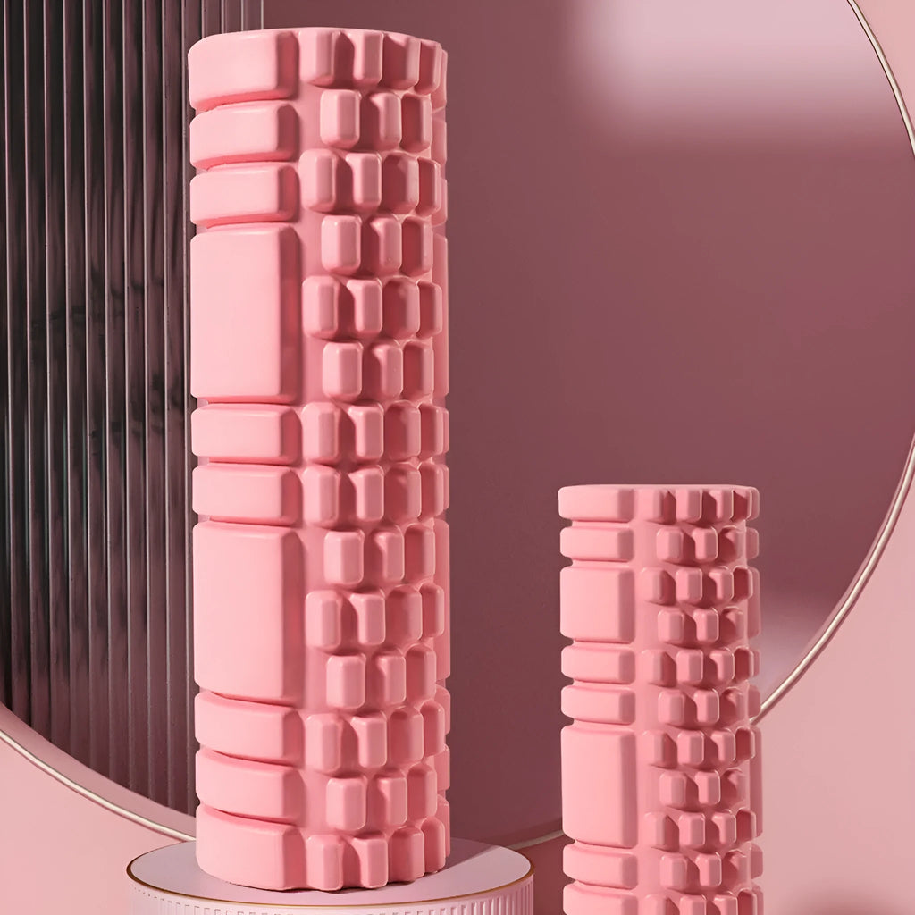 EVA foam roller in black, shown next to smaller pink and sky blue rollers of different sizes.