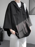 Man wearing a loose fit hooded short sleeve t-shirt in a solid colour, suitable for summer.